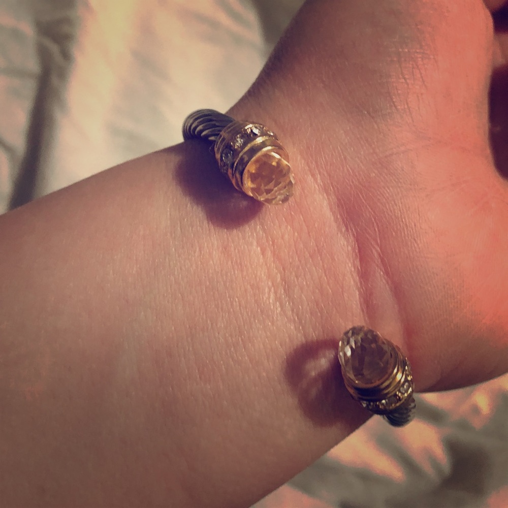 A silver bracelet and a white sparkly choker.